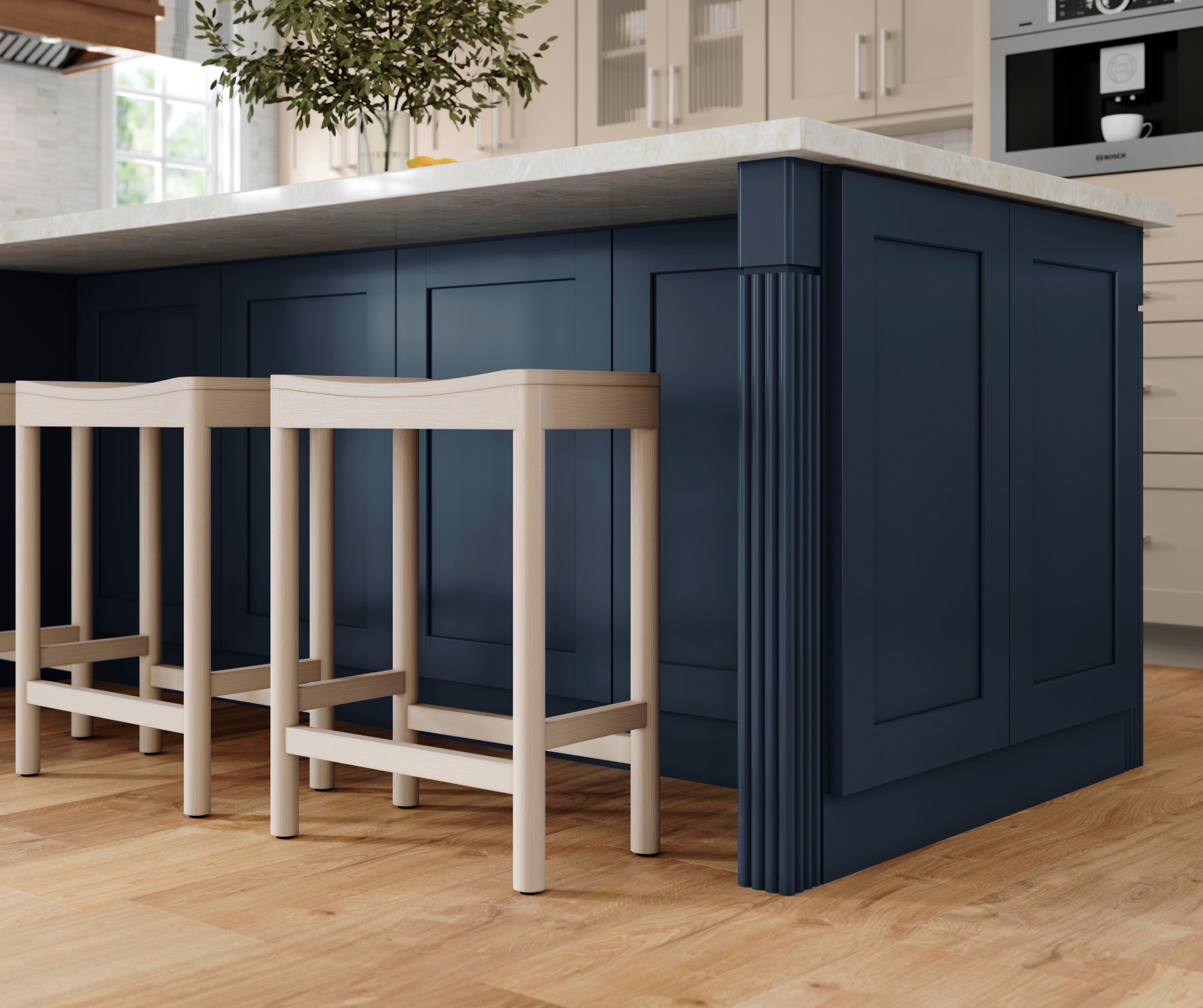 Painted navy kitchen island in a kitchen with painted oat cabinets